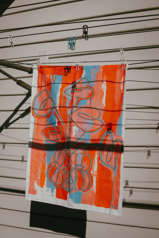 Printed tea towel by Melbourne artist Jay-Dee Pitcaithly hanging on a washing line