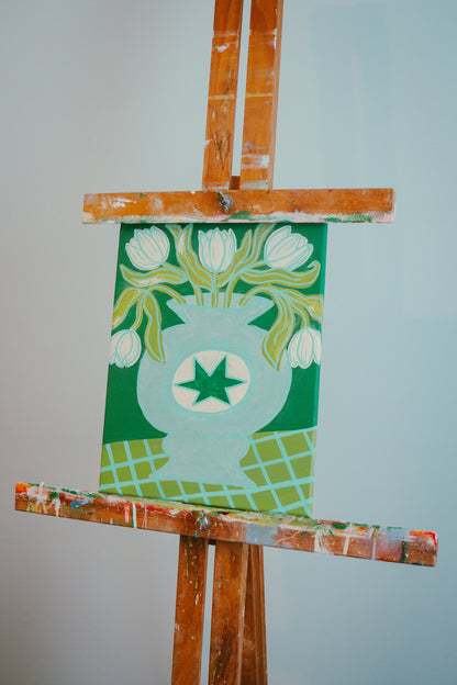 Wooden easel with a green, blue and cream original painting of tulips in a vase hand painted by Melbourne artist Jay-Dee Pitcaithly